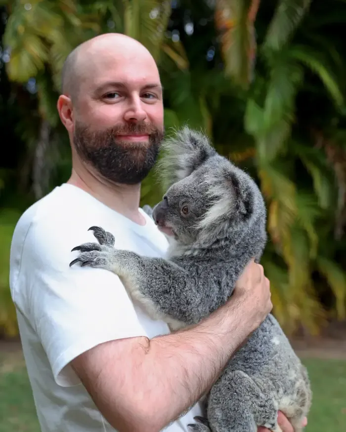 Portrait of Jack Coventry holding a koala